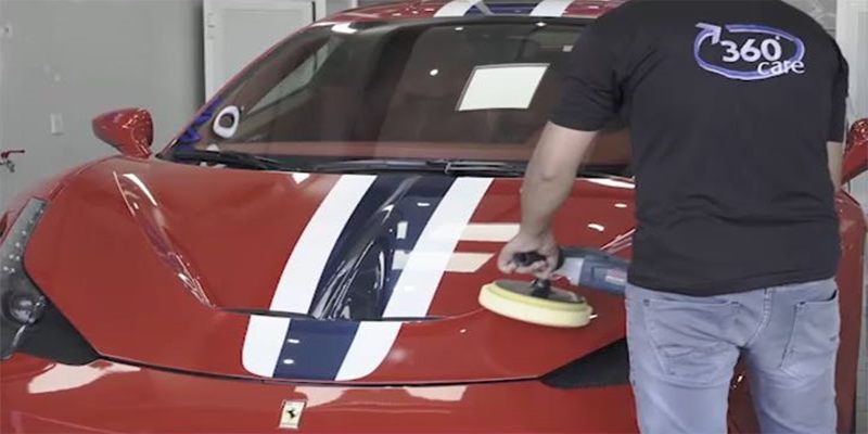 360 Care technician machine-polishing a red Ferrari