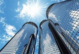 Glass office towers reflecting the sun