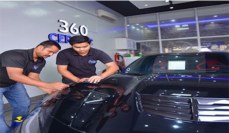Two 360 Care technicians working on a vehicle