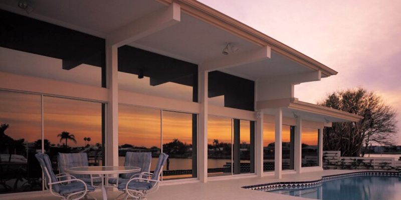 Solar film fitted to the glass of a waterfront villa at sunset