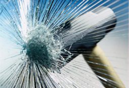 Security film holding shattered glass together after a hammer strike