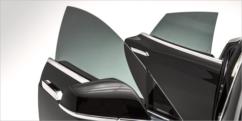 Tinted door glass on a dark saloon